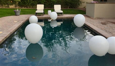 Floating Extra Large White Balloons In Our Pool For A Dinner Party