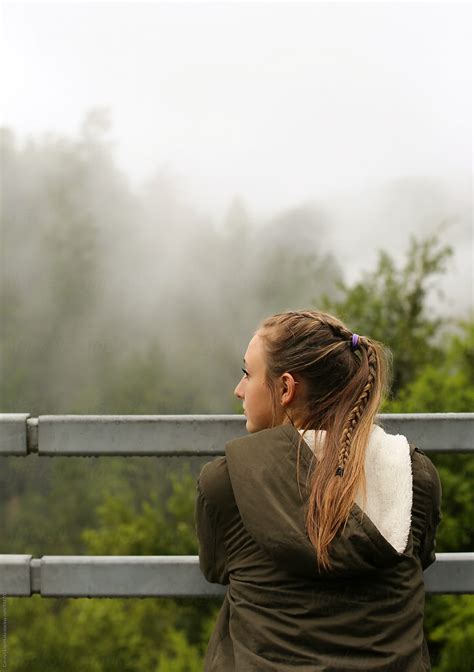 Teenage Girl Admiring A Beautiful Foggy View By Stocksy Contributor