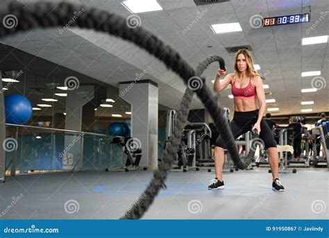 Woman With Battle Ropes Exercise In The Fitness Gym Stock Image
