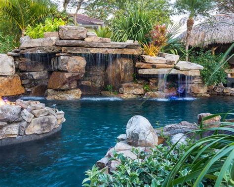 Custom Rock Waterfall Pool With Stone Grotto Stream And Tiki Hut