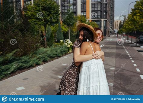 Happy Meeting Of Two Friends Hugging In The Street Stock Photo Image