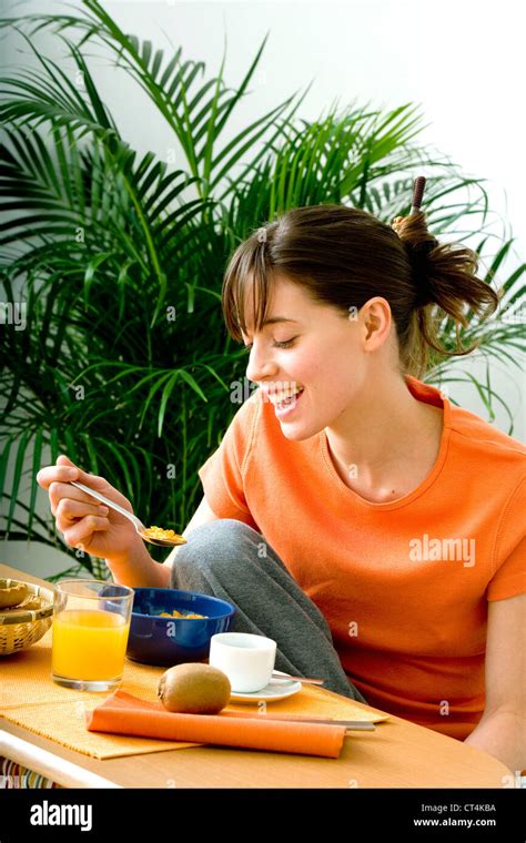 Woman Eating Breakfast Stock Photo Alamy