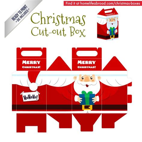 A Christmas Cut Out Box With Santa Claus Holding A Present In Front Of