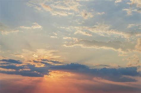 Stunning Sunset With Orange And Blue Clouds In Dramatic Sky Stock Photo