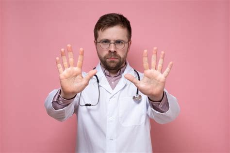 Serious Doctor With A Stethoscope Around Neck Shows A Stop Gesture