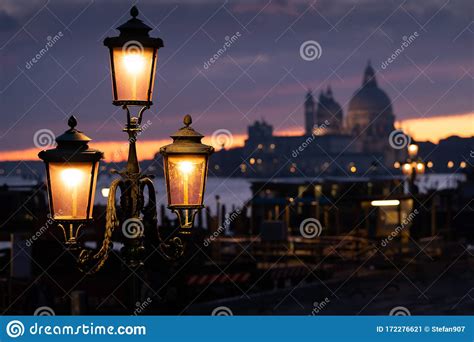 Lanterns In Front Of Sunset Behind Santa Maria Della Salute In Venice