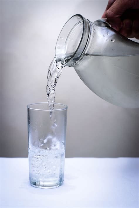Clear Glass Pitcher Pouring Water On Clear Drinking Glass · Free Stock