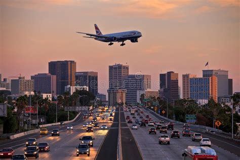 Jet Aircraft On Landing Approach Flying Low Over City Freeway Editorial