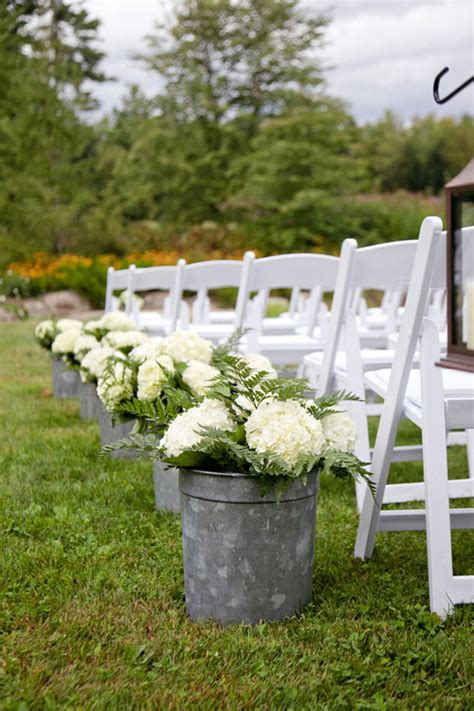 Learn how to make bows, cascading flowers and more for the perfect wedding decor. Rustic ivory hydrangea aisle decor for outdoor wedding - Photo by Emily Delamater | Wedding ...