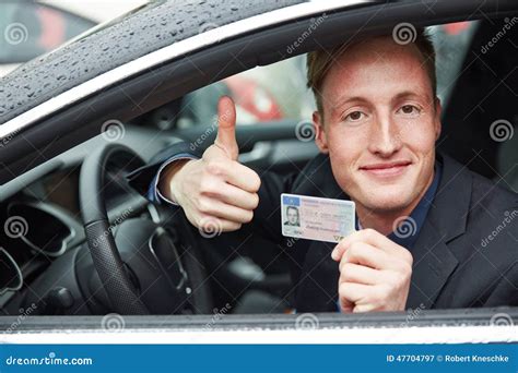 Young Man Holding Drivers Licence And Thumps Up Stock Image Image Of