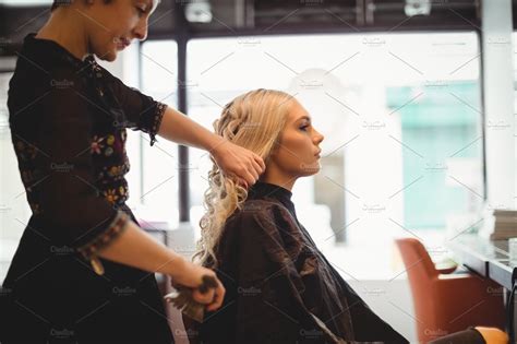 Female Hairdresser Styling Clients Hair High Quality Stock Photos