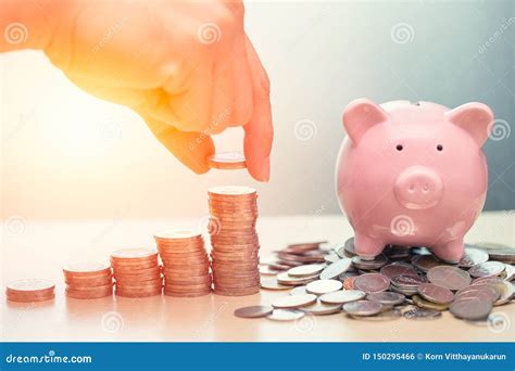 Saving Money To Pig Bank Piggy Bank With Stack Of Coin Stock Photo