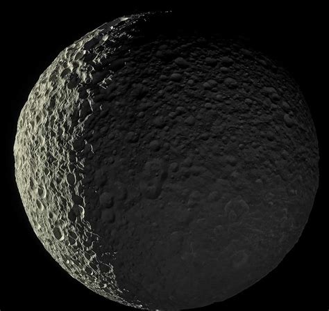 Mimas One Of Saturns Moons Is Bathed In Sunlight On One Side And