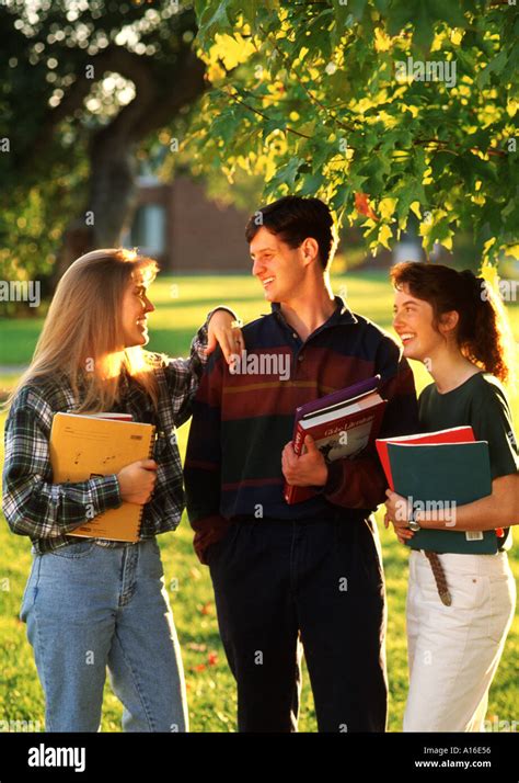 Attractive Young College Students Talking Together On Campus Stock