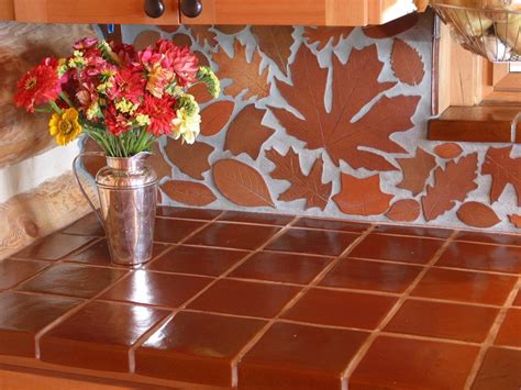 When you're chatting kitchen area backsplash suggestions, it doesn't get a lot easier than this. terracotta leaf backsplash and terracotta tile countertop ...