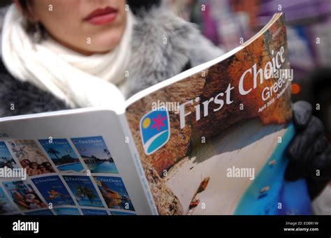 A Woman Browsing A First Choice Holiday Brochure Stock Photo Alamy