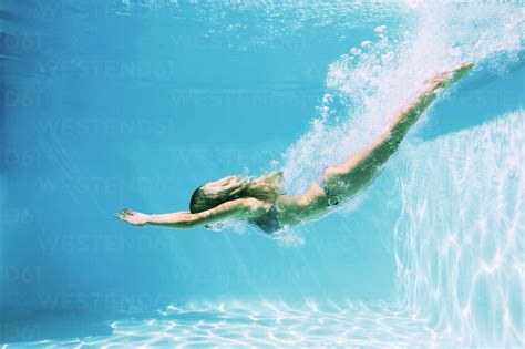 Woman Diving Into Swimming Pool Stock Photo