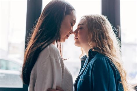 lesbian couple gathered kissing free photo