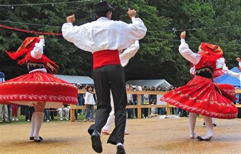 Men And Women In Traditional Dress Dancing At An Outdoor Event