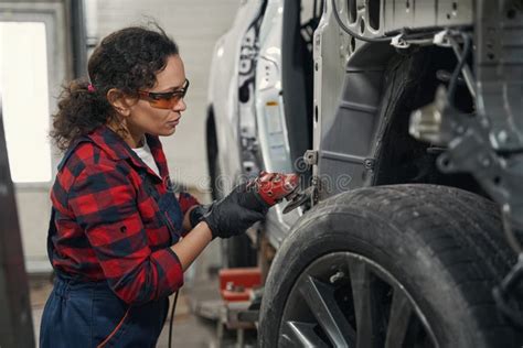 Woman Auto Mechanic Repairing Car At Repair Service Station Stock Image