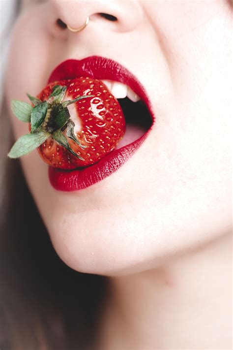Free Photo Woman With Red Lipstick Biting Strawberry Mouth Young Woman Free Download Jooinn