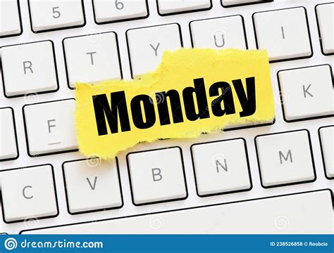 Monday On A Small Yellow Sheet Of Paper Lay On The Keyboard Stock Photo
