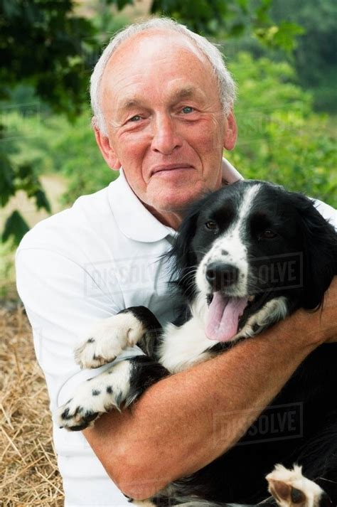 Senior Man Holding Dog Portrait Stock Photo Dissolve