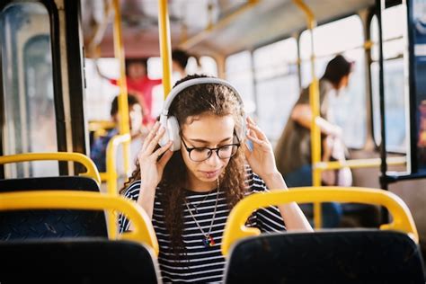 Premium Photo Young Girl With Headphones Sitting In A Bus