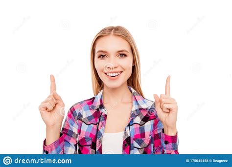 Cheerful Pretty Young Woman Pointing Up With Fingers Stock Photo
