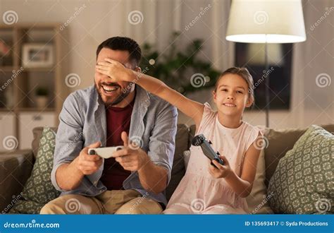 Father And Daughter Playing Video Game At Home Stock Image Image Of