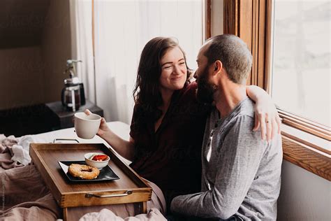 Couple Sharing Coffee In Bed Del Colaborador De Stocksy Leah Flores