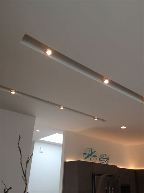 Using recessed lights for accent lighting is very effective because of their ability to blend with the ceiling. I love this use of recessed track lighting. It's supper ...