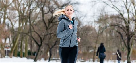 Woman Running Down A Path On Winter Day In Park Stock Photo Image Of
