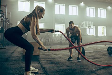 Woman With Battle Ropes Exercise In The Fitness Gym Stock Image