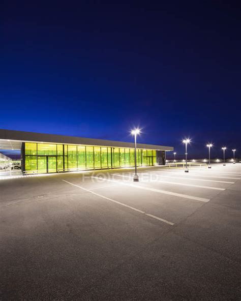 Empty Parking Lot And Building Illuminated At Night — Northern Europe
