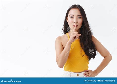 Sensual Girl Hiding Some Secret Or Prepare Surprise Attractive Asian Brunette In Yellow Top