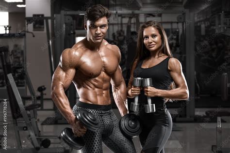 Sporty Sexy Couple Showing Muscle And Workout In Gym Muscular Man And