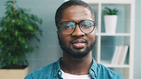 Portrait Of African Attractive Man In Glasses Looking On Side Turning