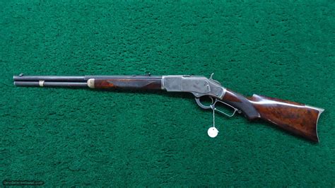 The brass cartridge lifter serves triple duty as lifter, mechanical ejector, and magazine cutoff. DELUXE WINCHESTER MODEL 1873 SHORT RIFLE