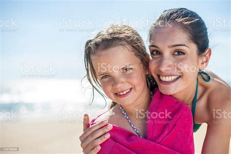 Mom At The Beach Wrapping Her Girl In A Towel Stock Photo Download