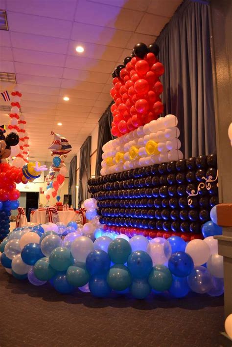 Mickey Mouse Balloon Sculpture In An Office Hallway With Balloons And