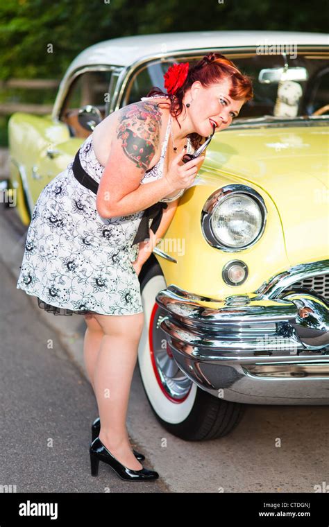 A Pinup Model Poses Next To A Classic Vehicle Stock Photo Alamy