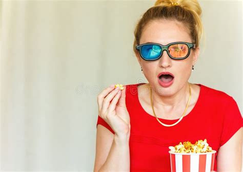 Young Woman Watching Tv While Sitting On A Sofa With 3d Glasses And Popcorn With Pleasure Stock