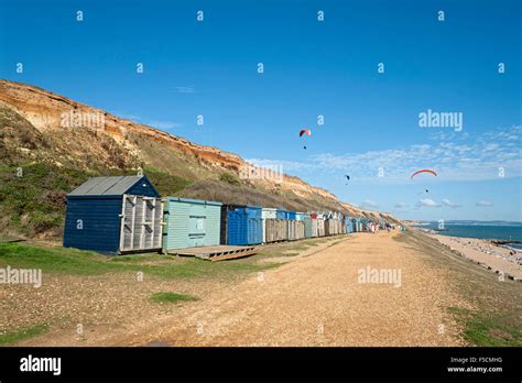 Barton On Sea Beach Hampshire With Paragliders And Beach Huts Stock