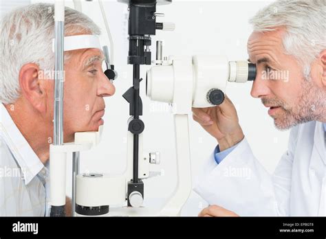 Optometrist Doing Sight Testing For Senior Patient Stock Photo Alamy