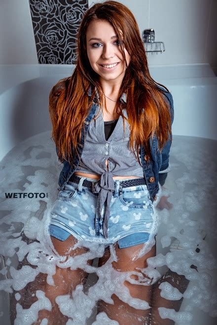 wetlook by sexy girl in fully wet jacket denim shorts stockings and sneakers in shower