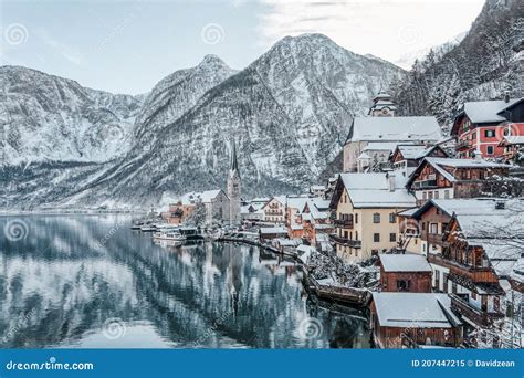 Snowy Village Hallstatt By Lake At Foot Of Snow Mountain With Clear Sky