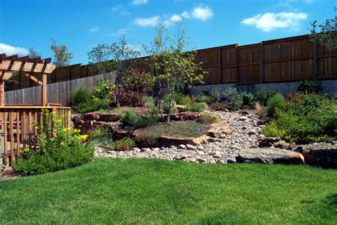 Sloped yards naturally help break up the different spots in your yard, and these landscaping ideas for slopes help accentuate that. Landscaping Ideas For A Small Sloped Backyard | Mystical ...