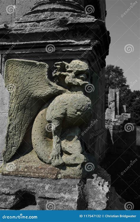 Grotesque Gargoyle Water Spout Sculpture On Facade Of Gothic Medieval