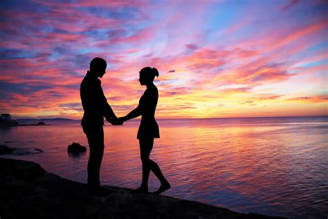 Couple Facing Each Other On Seashore During Sunset Hd Wallpaper